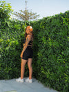 CHELSEA in the BLACK Lavish Bike Shorts and Majestic Bra styled criss cross at the front facing the back with her head to the front to show off the back of the shorts.